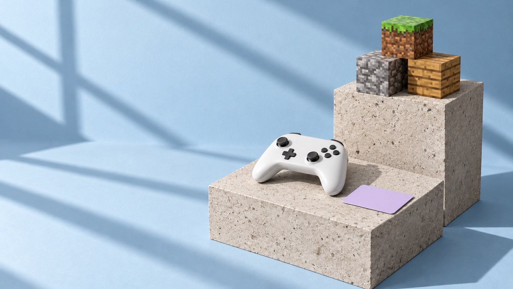A white game controller and three Minecraft-style blocks of grass, stone and wood on concrete steps against a pale blue wall